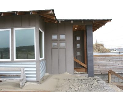 Built on sand with concrete floors, this custom home in Waldport, OR is designed to harmonize naturally with its surroundings while enduring the harsh conditions of the PNW coast.